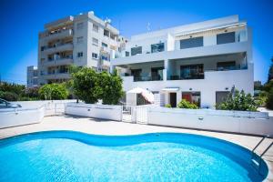 a house with a swimming pool in front of a building at Gardenia 104 Near The Beach in Limassol