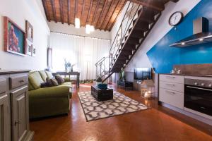 a large living room with a couch and a tv at Canto degli Scali in Florence