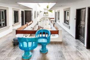 a large hallway with a blue chair in the middle at Valentina Suites by Las Flores Vacation Rentals in Playa del Carmen