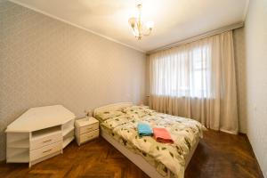 Ένα ή περισσότερα κρεβάτια σε δωμάτιο στο Квартира по улице Большая Васильковская, 101