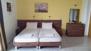 a bedroom with a bed and a dresser in it at Galini Apartments in Plakias