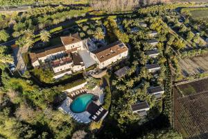 an aerial view of a resort with a pool and a building at Donna Carmela Resort & Lodges in Riposto