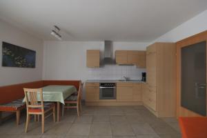 a kitchen with a table and a table and chairs at Ferienwohnungen Matzner in Admont