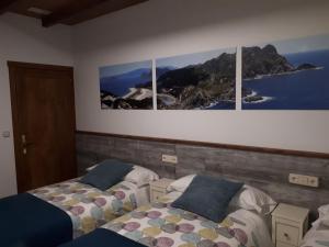 En eller flere senge i et værelse på Pension Vilanova