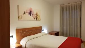 Cama o camas de una habitación en Apartamentos Puerta Muralla