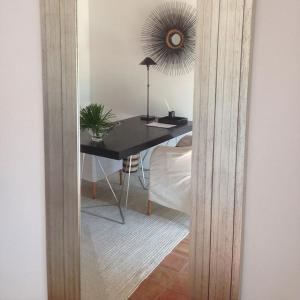 a mirror reflection of a desk in a room at Quinta da Lua in Tavira