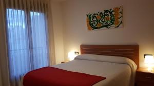 Cama o camas de una habitación en Apartamentos Puerta Muralla