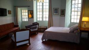 サルラ・ラ・カネダにあるLa Salamandreのベッドルーム1室(ベッド1台、ソファ、窓付)
