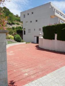 a building with a red brick driveway next to a building at Cala Azul 304-306 Tamarit in Tamarit