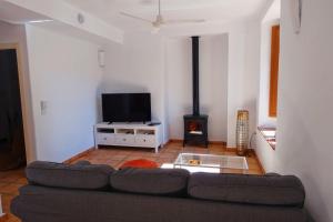 a living room with a couch and a fireplace at Betania in Grazalema