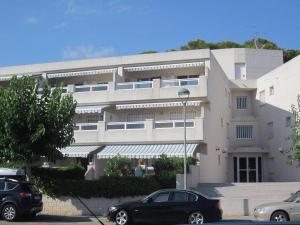 a large building with cars parked in front of it at Cala Azul 304-306 Tamarit in Tamarit