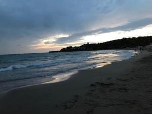 a beach with people walking on the sand and the ocean at Cala Azul 304-306 Tamarit in Tamarit