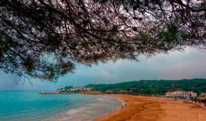 a view of a beach with people on it at Cala Azul 304-306 Tamarit in Tamarit