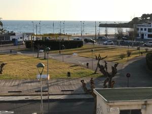 a view of a street with the ocean in the background at Cala Azul 304-306 Tamarit in Tamarit