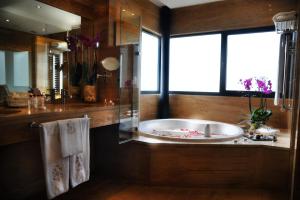 a bathroom with a tub, sink, and bathtub at Hotel Pazo Los Escudos Spa & Beach in Vigo