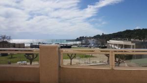 a balcony with a view of the ocean and a beach at Cala Azul 304-306 Tamarit in Tamarit