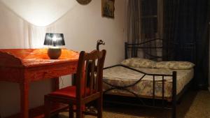 a bedroom with a bed and a desk with a lamp at Amazing View Dream House in Chora Folegandros