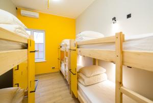 a room with three bunk beds and a window at HOTEL Bee Station in Kyiv
