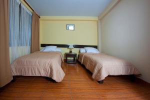 Säng eller sängar i ett rum på Yucay Plaza Inn
