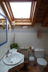 a bathroom with a sink and a toilet and a window at La Casa de Bernuy in Bernúy de Porreros +29 photos