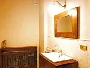 a bathroom with a sink and a mirror at Charme of Villa Capannina in Novi Ligure