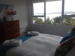a bedroom with a large bed with two towels on it at Panorama Heights Apartment in Paihia