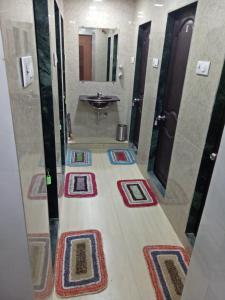 a large bathroom with a sink and a mirror at Royal Dormitory in Mumbai
