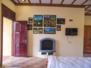 a living room with a fireplace and a tv at Dong Van B&B in Dồng Văn