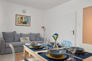 a dining room with a table and a couch at Brand new Lozenets APT in Sofia