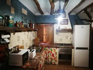 a kitchen with a refrigerator and a counter top at Cortijo Los Soledad in El Sauco
