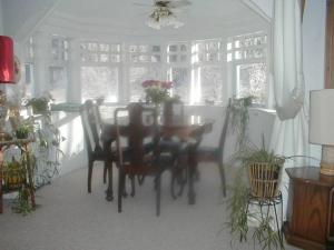 a dining room with a table and chairs and windows at Mountain Valley Retreat in Killington +39 photos