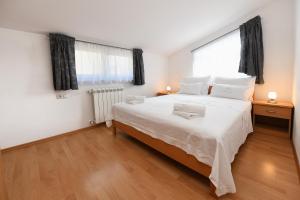 Posteľ alebo postele v izbe v ubytovaní Apartment AnaKatarina