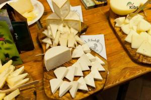 a wooden table topped with cheese and other foods at I Filadelfi 1828 in Cicerale