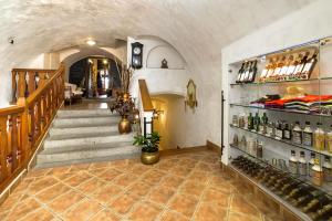 a room with a staircase and a shelf of wine bottles at Arcadie Hotel & Apartments in Český Krumlov