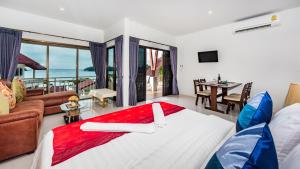 a bedroom with a bed and a living room at Da Bungalows in Kata Beach