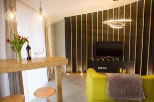 a living room with a dining table and a television at Apartamenty Centrum in Gorzów Wielkopolski