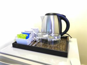 a coffee pot on a tray on a counter at Pattaya At Nine in Pattaya