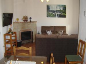 a living room with a couch and a fireplace at Casa El Pinsapar in El Bosque