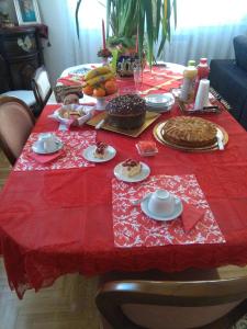 a table with a red table cloth with food on it at La Castellese in Aci Castello
