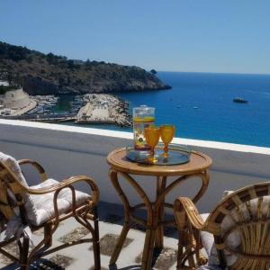 a table with two glasses on top of a balcony at Appartamento Stefania in Castro di Lecce