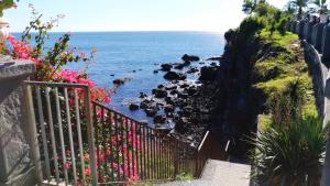 a staircase leading down to a body of water at La Castellese in Aci Castello