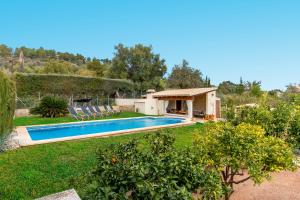 a swimming pool in a yard with a house at Ca Na Rosa in El Port de la Selva