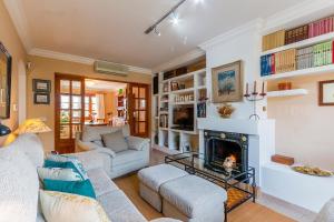 a living room with two couches and a fireplace at Ca Na Rosa in El Port de la Selva