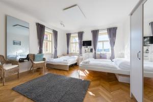 a bedroom with two beds and a mirror at Kafka Apartment with bridge view in Prague