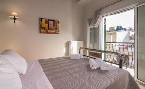 a bedroom with a bed with two towels on it at Semeli Apartment in Zakynthos Town