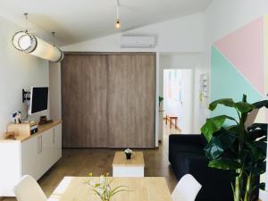 a living room with a blue couch and a sliding door at Gite Blanco y Madera in Narbonne