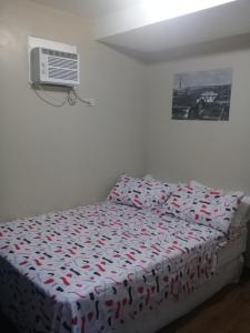 a bedroom with a bed and a air conditioner at Mmr in Manila