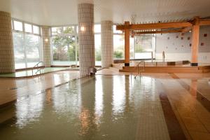 a room with a pool of water in a building at Oehonke in Kitami
