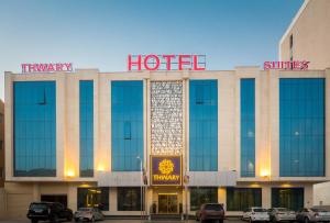 a hotel with cars parked in front of it at Thwary Hotel Suites in Riyadh