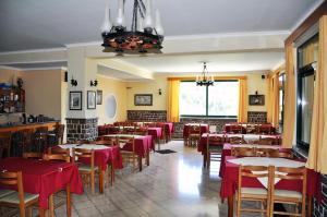 a restaurant with tables and chairs in a room at Hotel Filoxenia in Ligia +23 photos